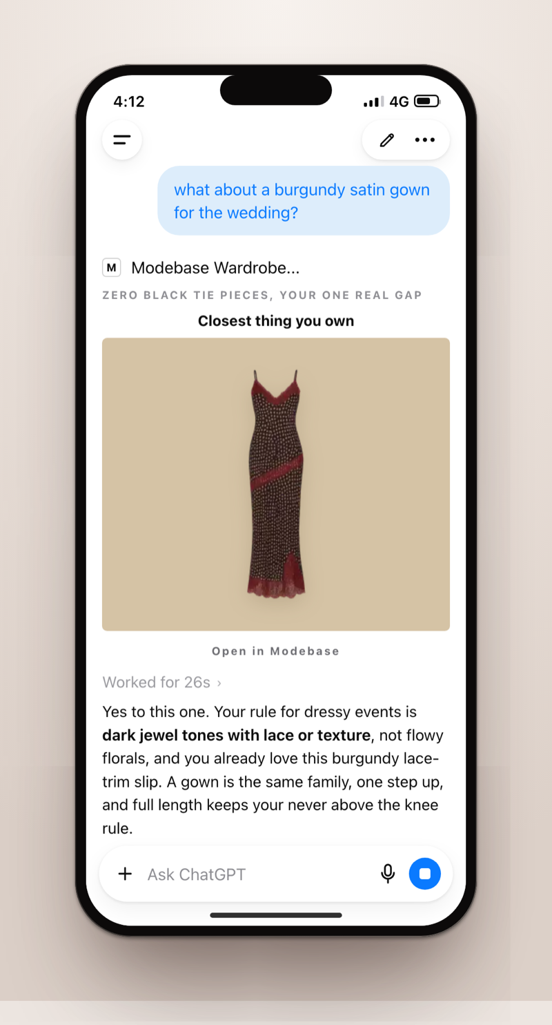 A phone screenshot of ChatGPT answering 'what about a burgundy satin gown for the wedding?' with the closest dress you already own, a burgundy lace-trim slip, and a note on why it fits your dressy-events rule
